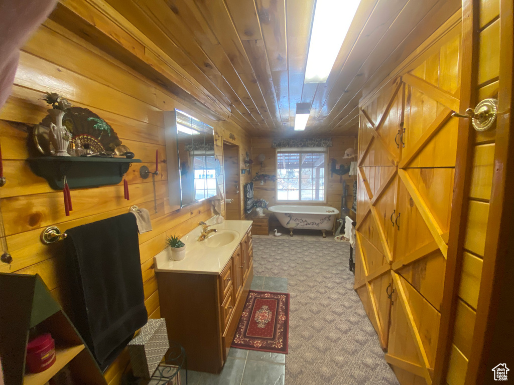 Interior space featuring vanity, wooden walls, and wood ceiling