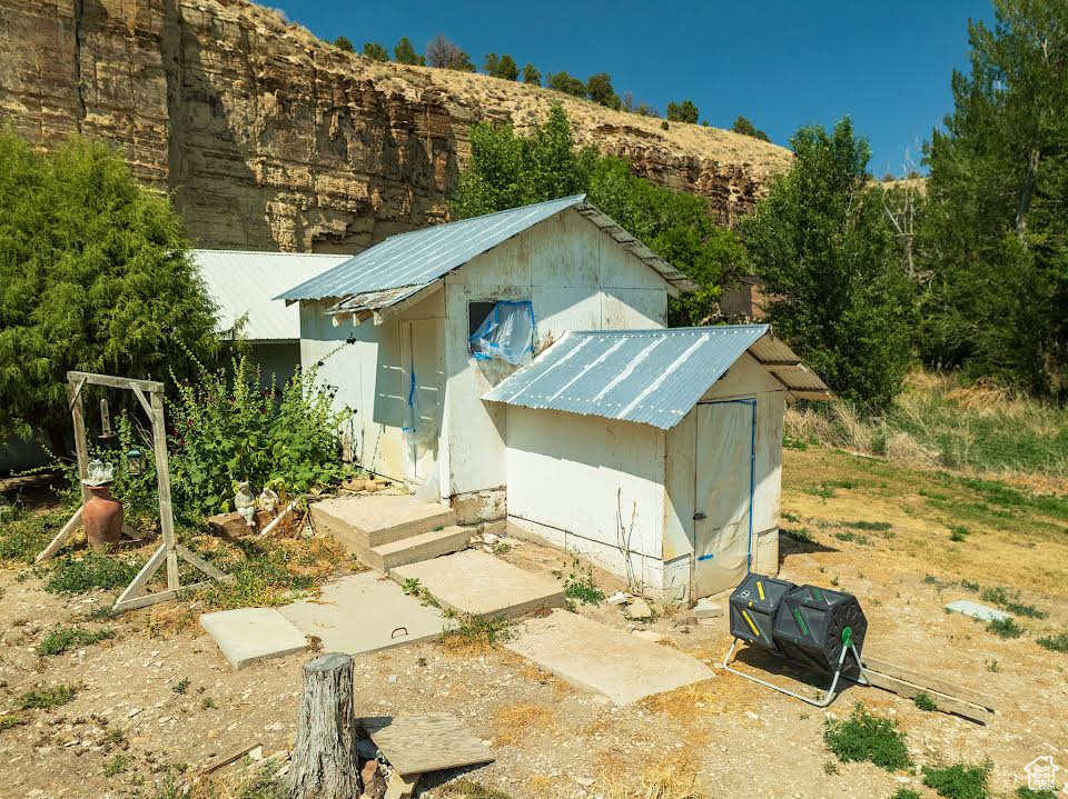 View of front of house featuring a shed