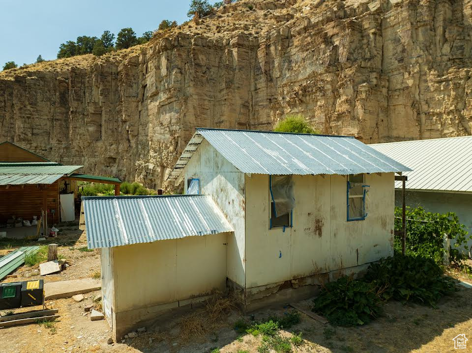 View of side of property featuring an outdoor structure