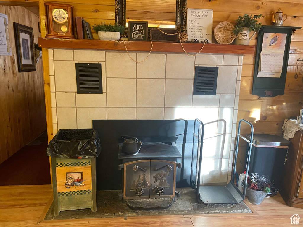 Room details featuring wood-type flooring and wood walls