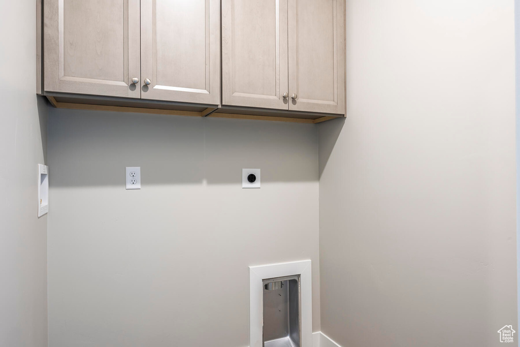 Washroom with cabinets and electric dryer hookup