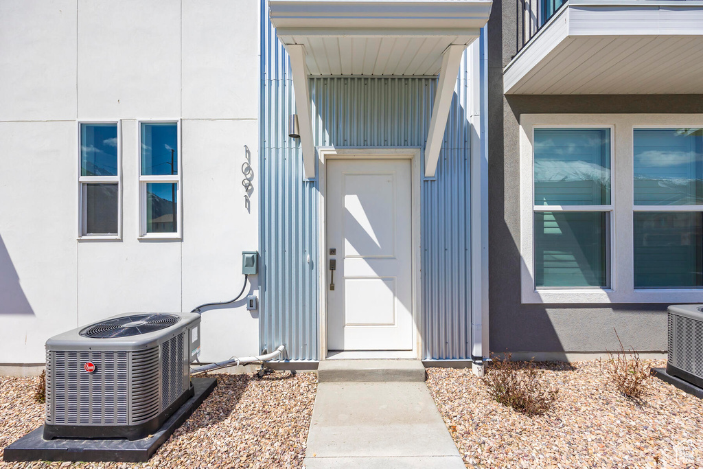 Property entrance featuring central AC unit