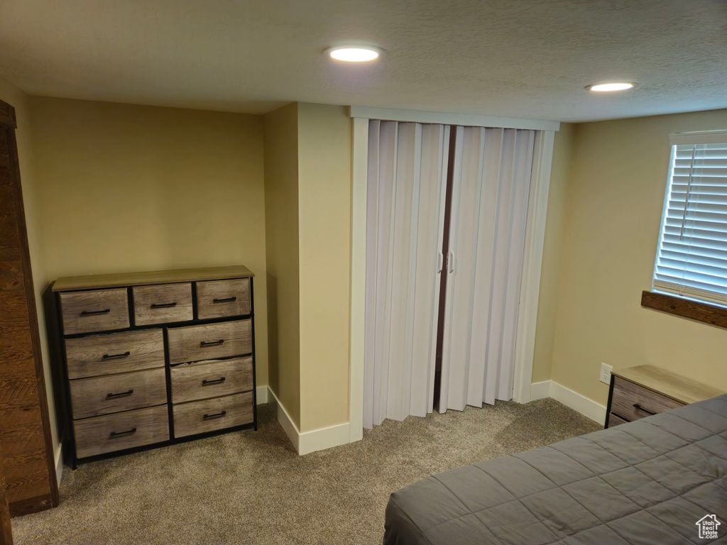 Bedroom with carpet and a textured ceiling