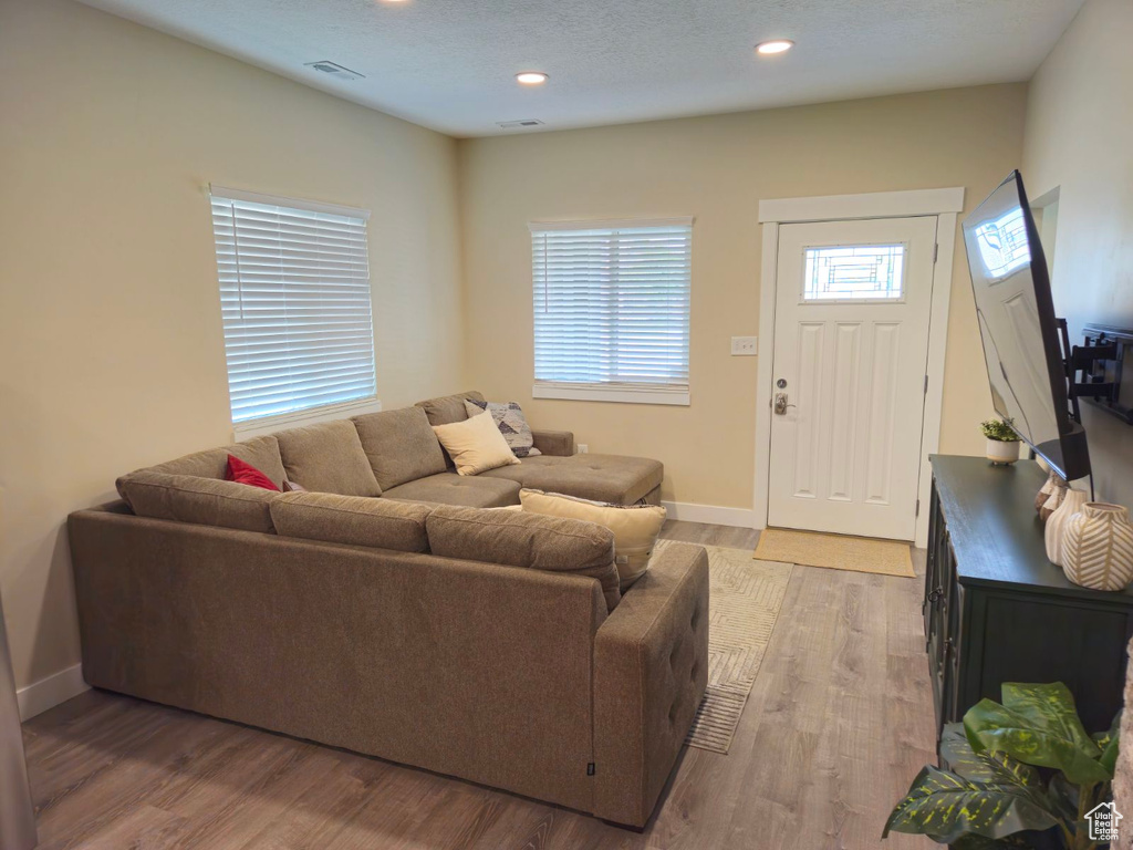 Living room with light hardwood / wood-style flooring