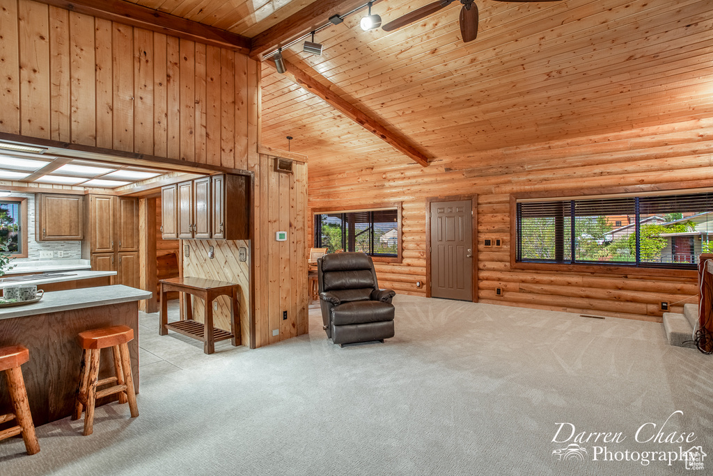 Interior space featuring light carpet, a wealth of natural light, and ceiling fan