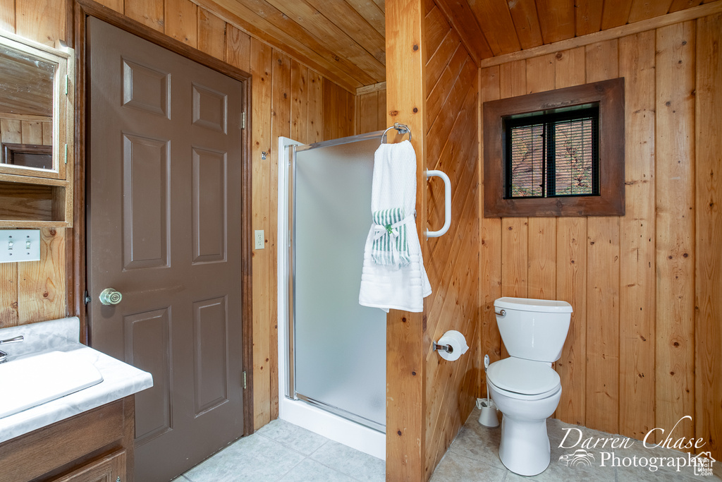 Bathroom with an enclosed shower, wood walls, toilet, vanity, and wooden ceiling