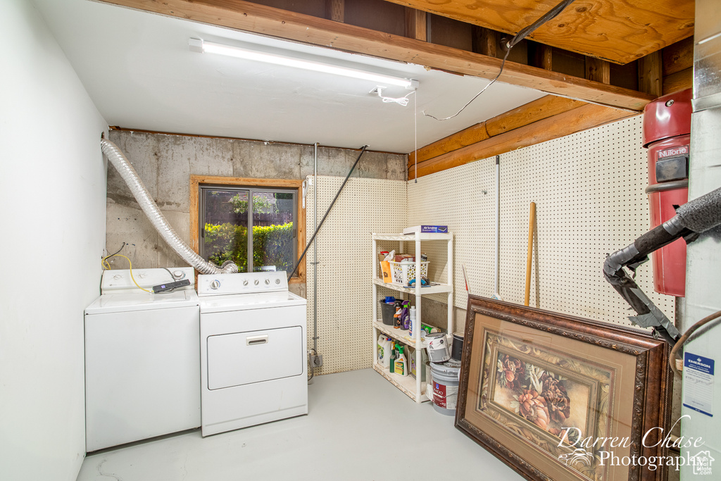 Clothes washing area featuring washing machine and clothes dryer