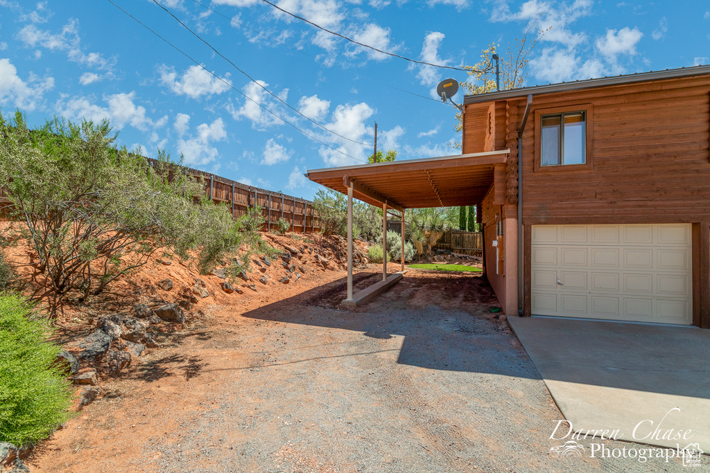 Exterior space featuring a garage and a carport