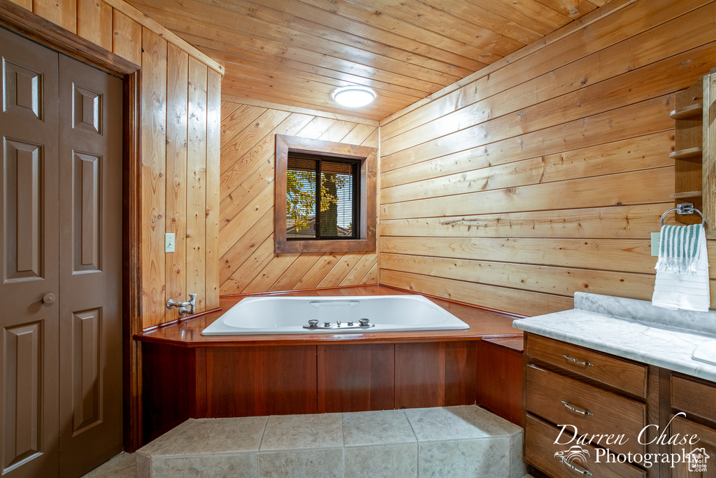 Bathroom with a bathtub, wooden walls, and wooden ceiling