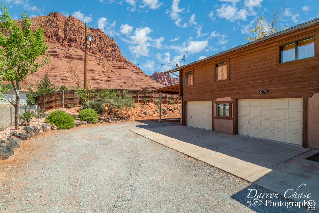 View of side of home with a garage and a mountain view