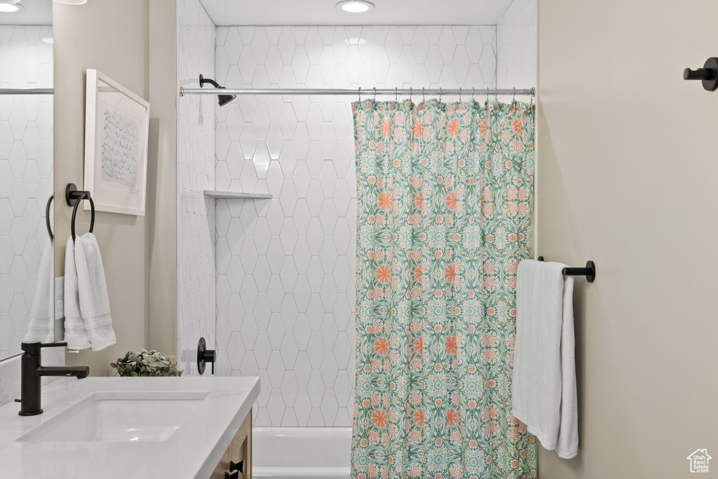 Bathroom featuring vanity and shower / tub combo