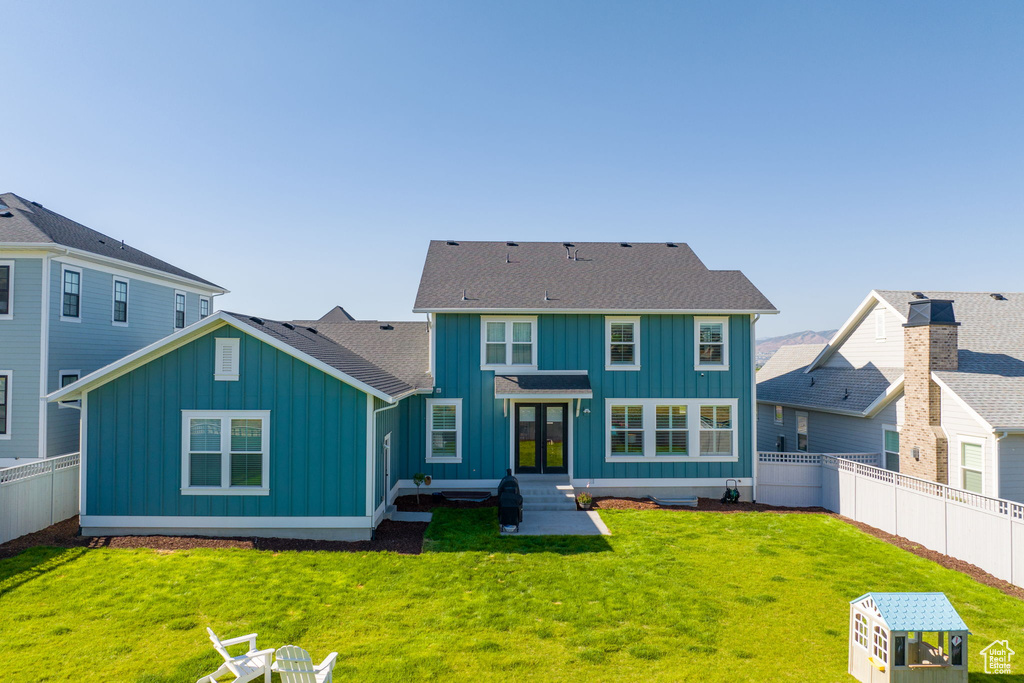 Rear view of property featuring a lawn