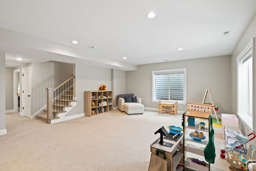 Game room with light colored carpet