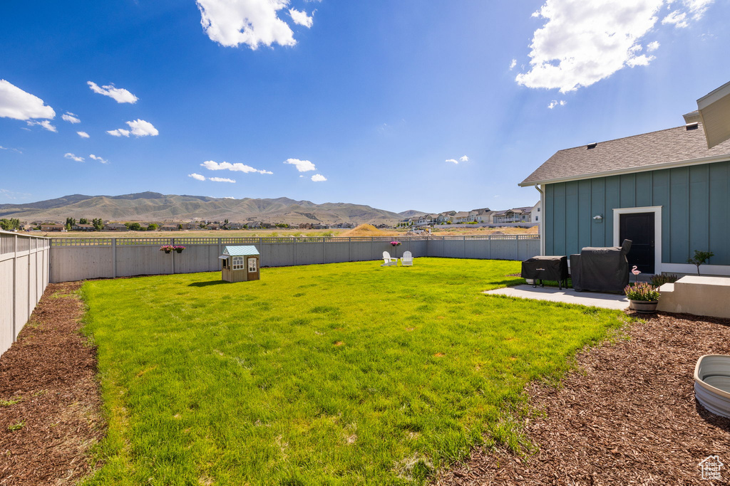 View of yard with a mountain view and a patio area