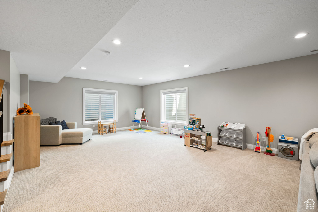 Recreation room featuring light colored carpet