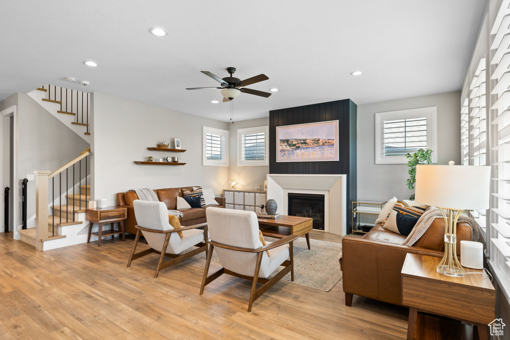 Living room featuring light hardwood / wood-style flooring and ceiling fan