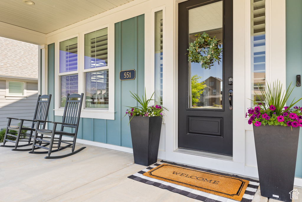 View of exterior entry featuring covered porch