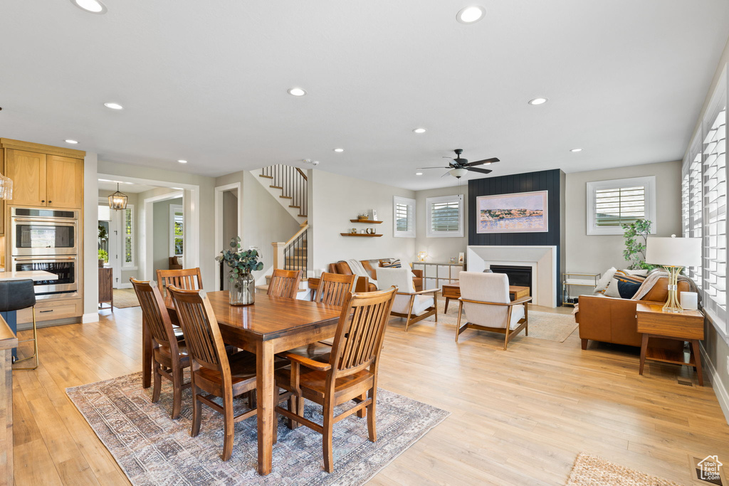 Dining room with light hardwood / wood-style floors and ceiling fan