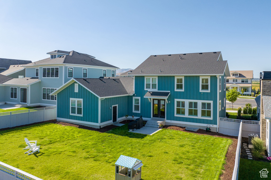 Rear view of property featuring a lawn