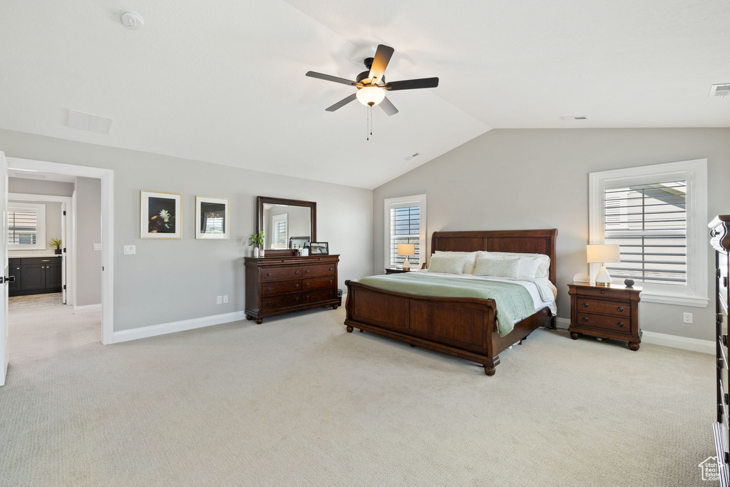 Carpeted bedroom featuring ceiling fan and lofted ceiling