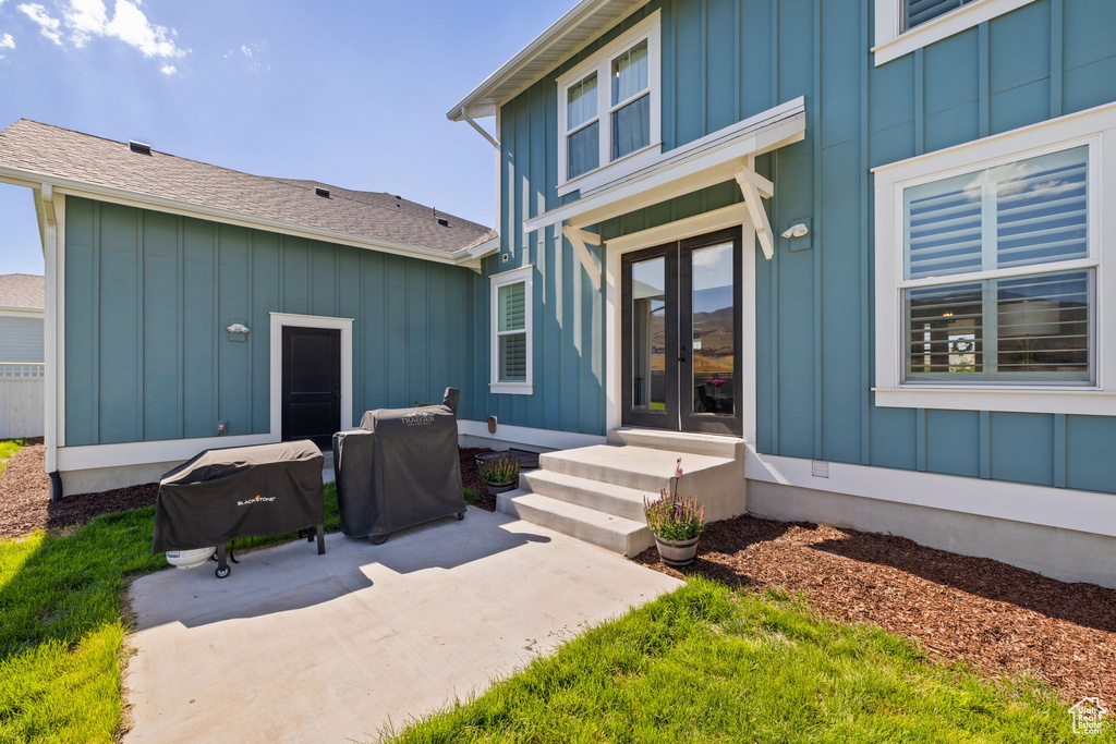 Doorway to property with a patio area