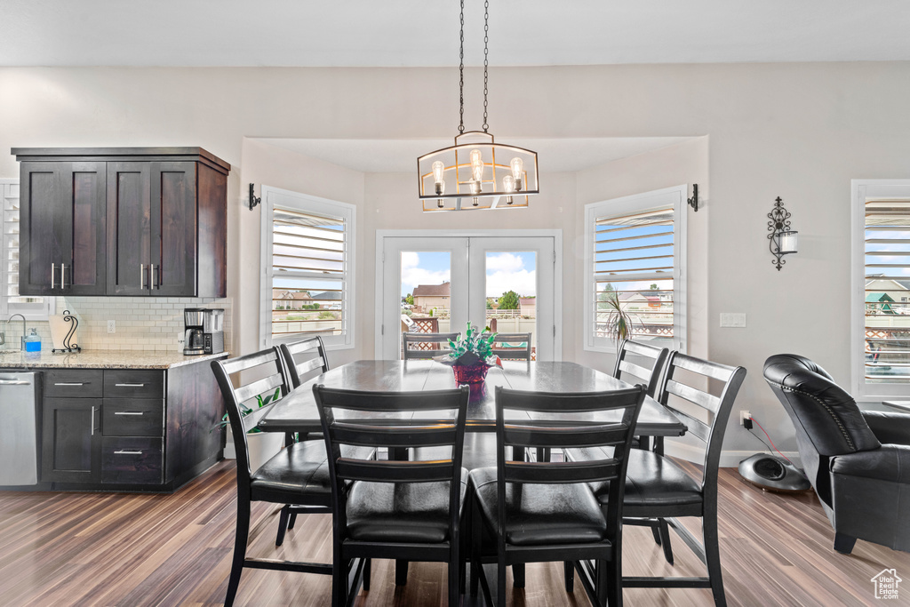 Dining space featuring wood-type flooring and a chandelier