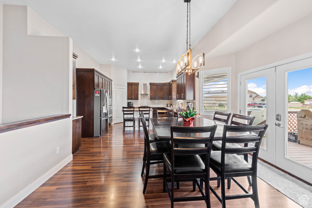 Dining room featuring an inviting chandelier, dark hardwood / wood-style flooring, and french doors