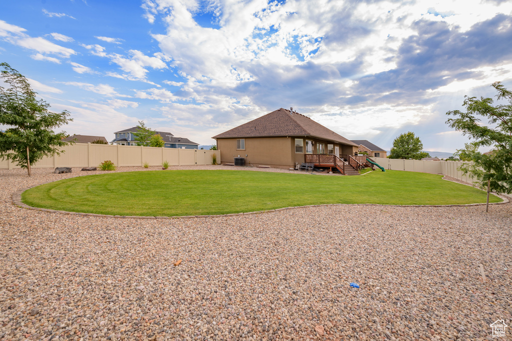 Exterior space featuring a deck and a lawn