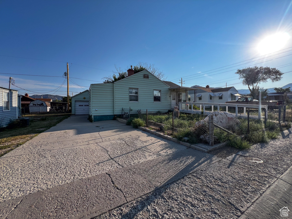 View of front of property featuring an outdoor structure and a garage