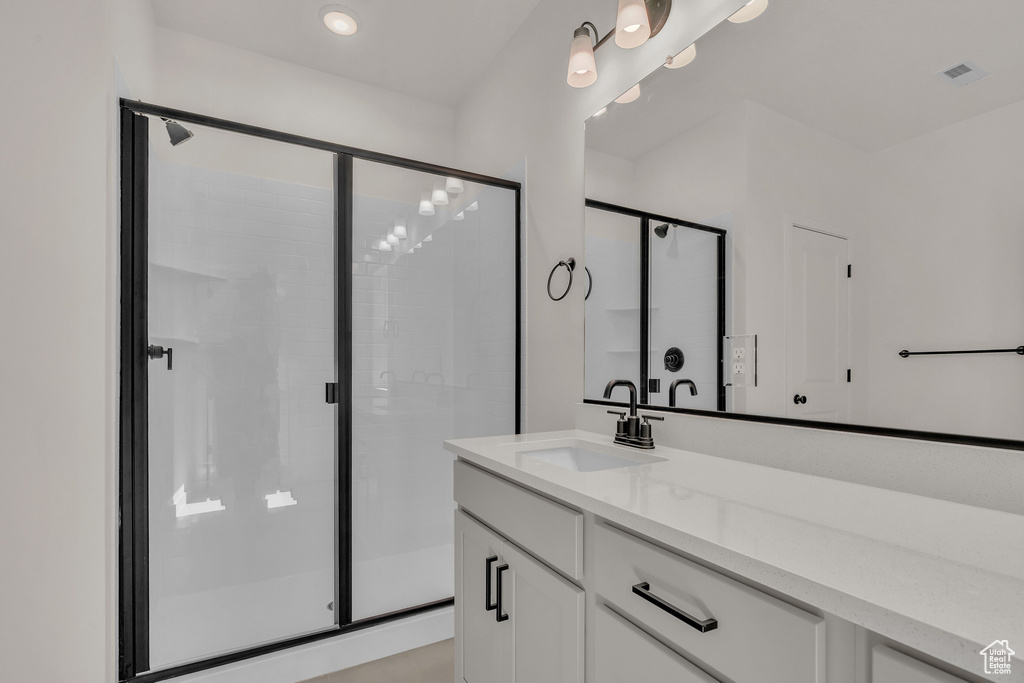 Bathroom with a shower with door and vanity