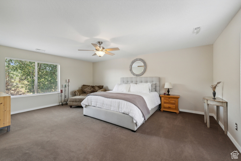 Bedroom featuring dark colored carpet and ceiling fan