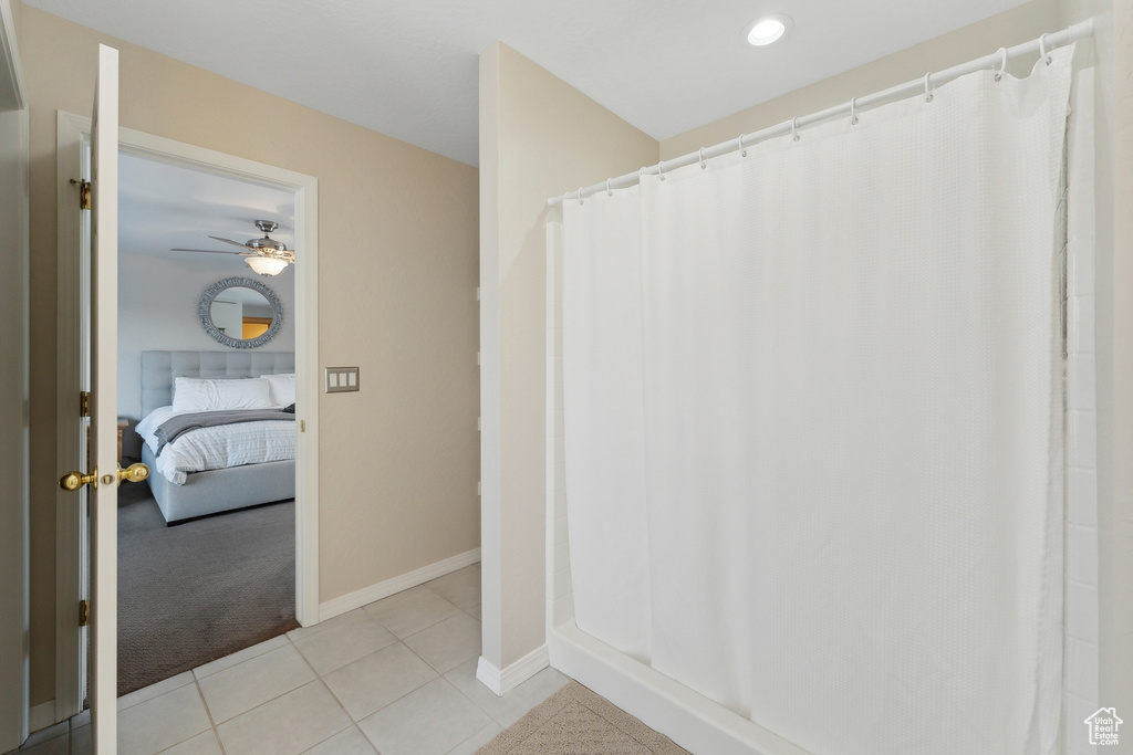 Bathroom with tile patterned flooring and ceiling fan