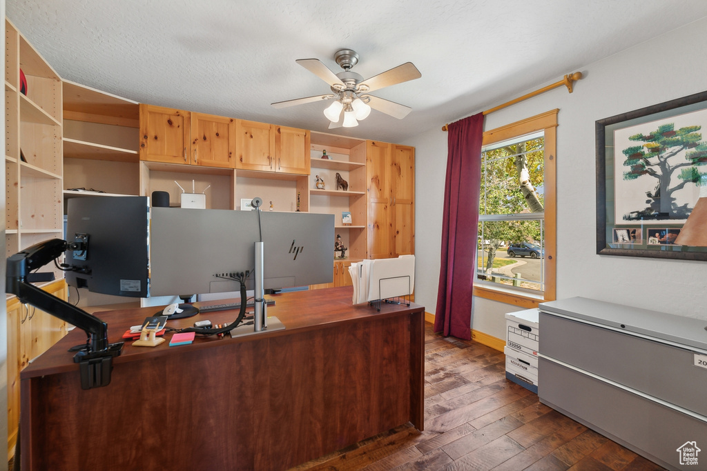 Office area featuring dark hardwood / wood-style flooring, a textured ceiling, and ceiling fan