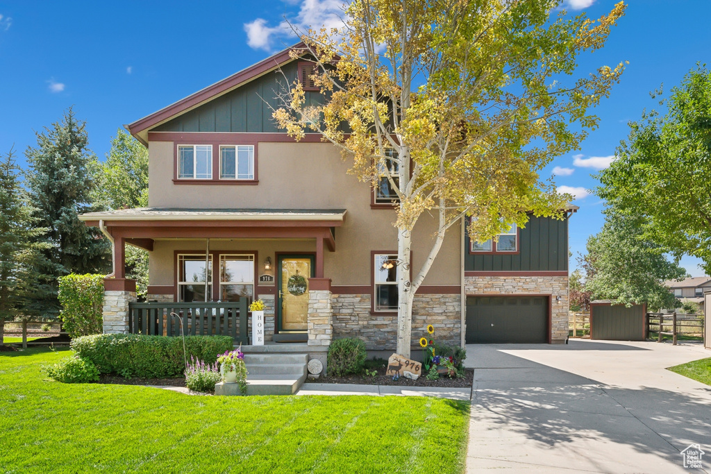 Craftsman-style home with a garage and a front yard