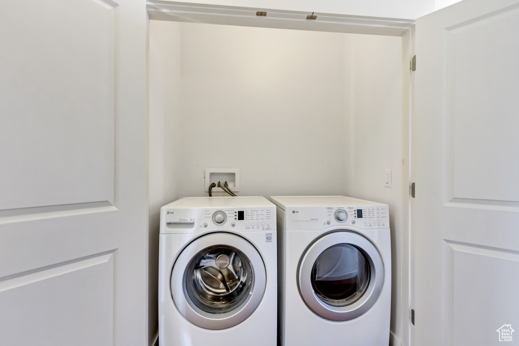 Laundry room featuring washer and clothes dryer