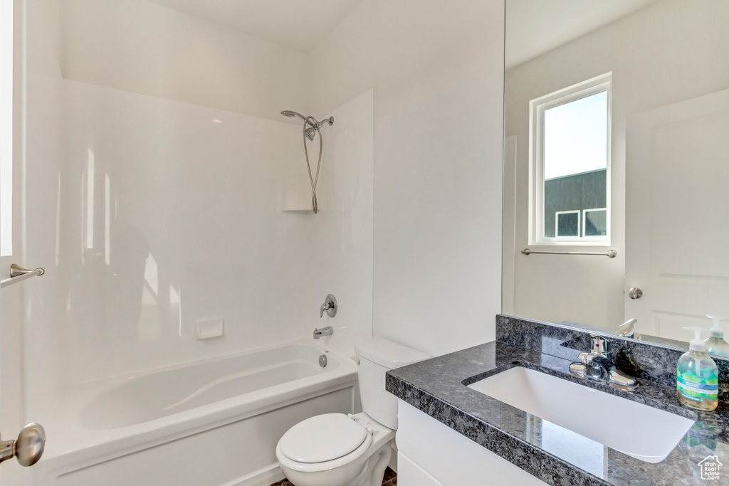 Full bathroom with vanity, shower / washtub combination, and toilet