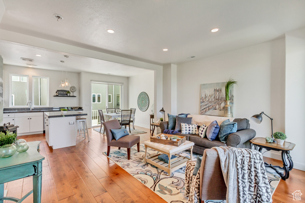 Living room featuring sink and light hardwood / wood-style floors