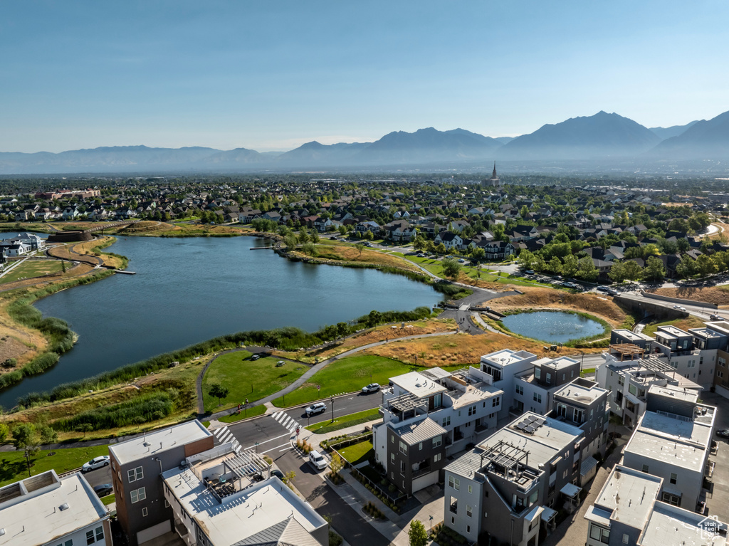 Drone / aerial view featuring a water and mountain view