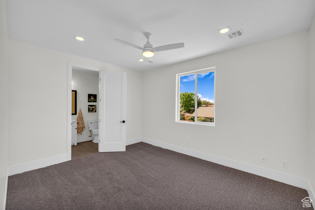 Empty room featuring carpet and ceiling fan