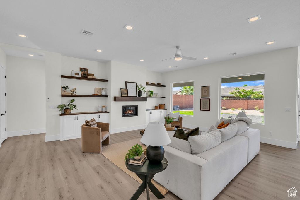 Living room featuring light hardwood / wood-style floors and ceiling fan