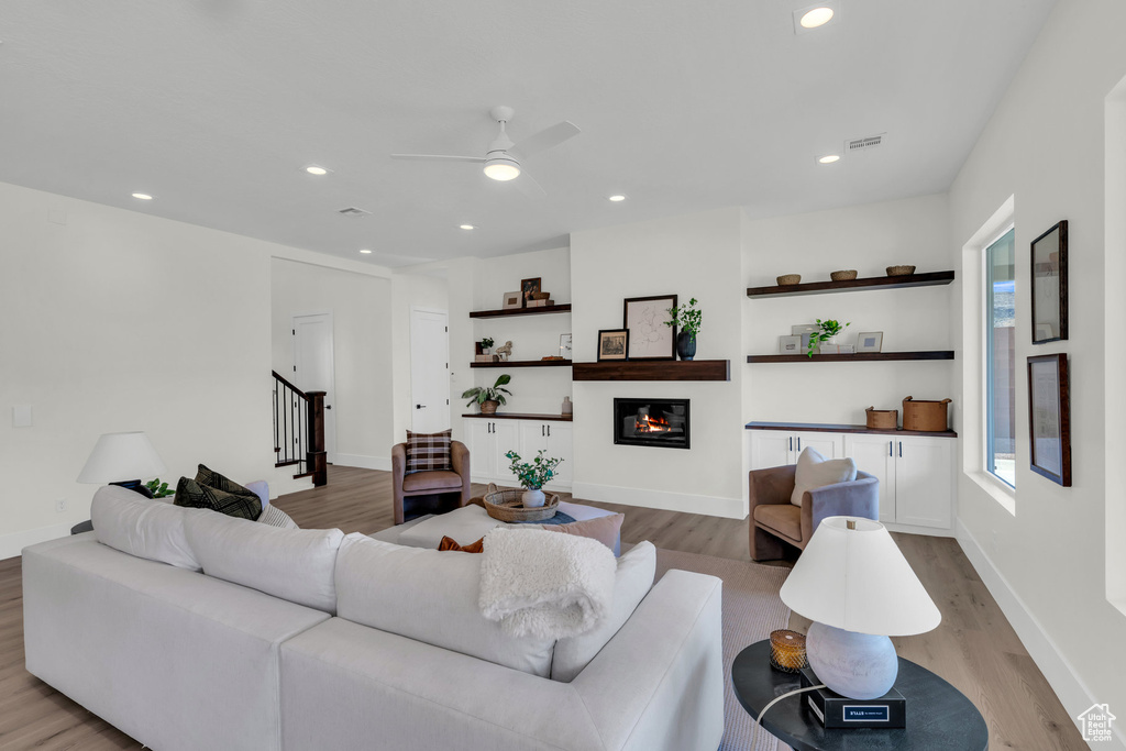 Living room featuring light hardwood / wood-style floors and ceiling fan