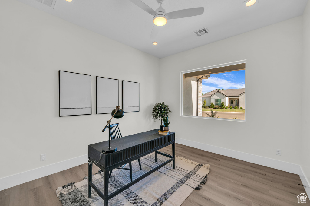 Home office featuring ceiling fan and hardwood / wood-style flooring