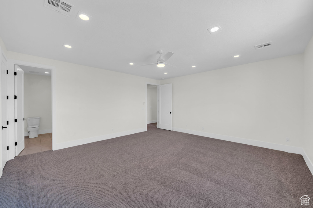 Empty room with ceiling fan and light colored carpet