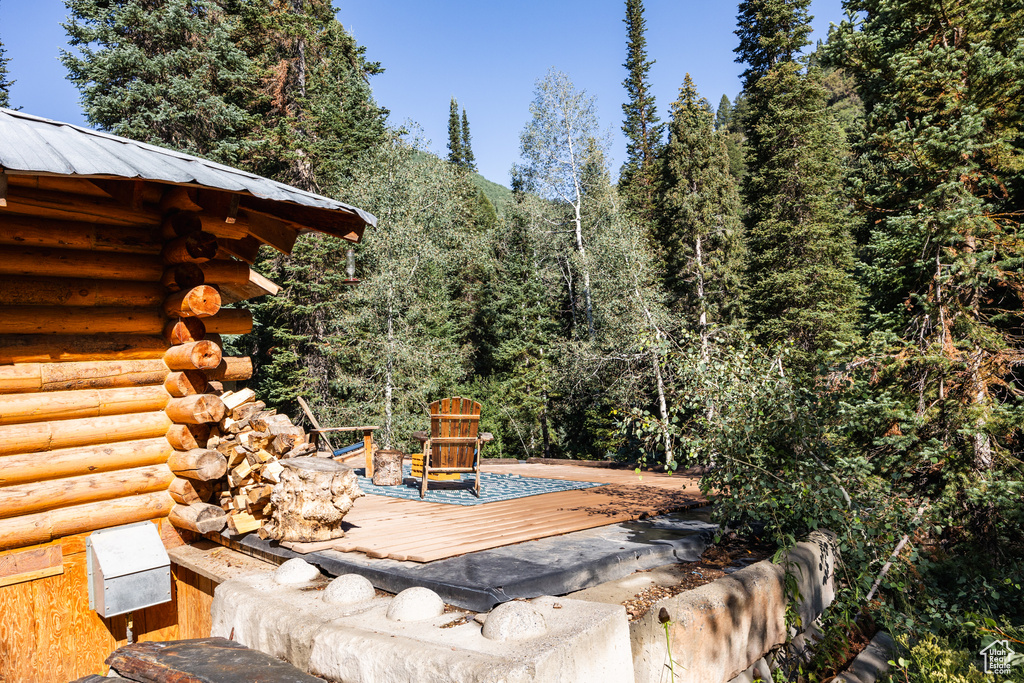 View of patio with a wooden deck