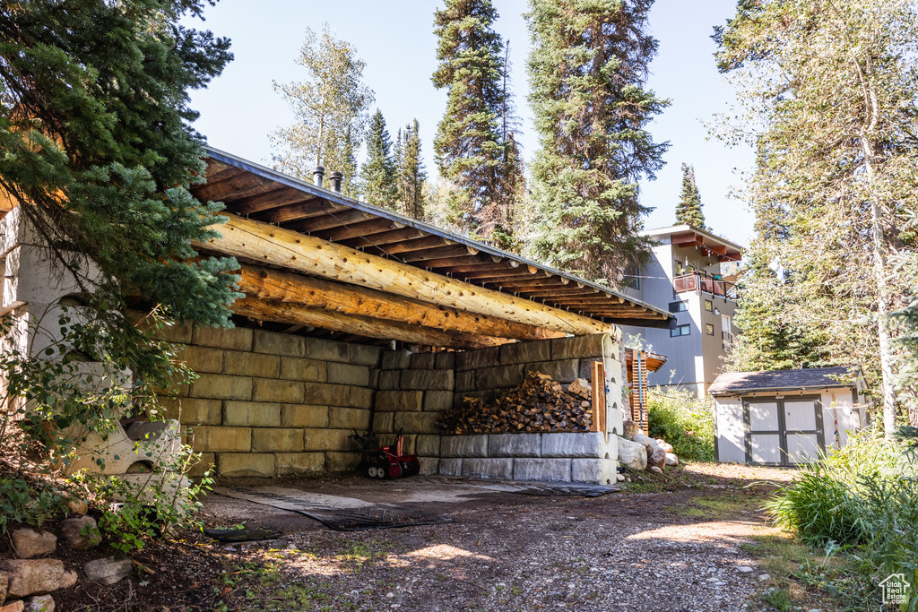 View of property exterior featuring a storage unit