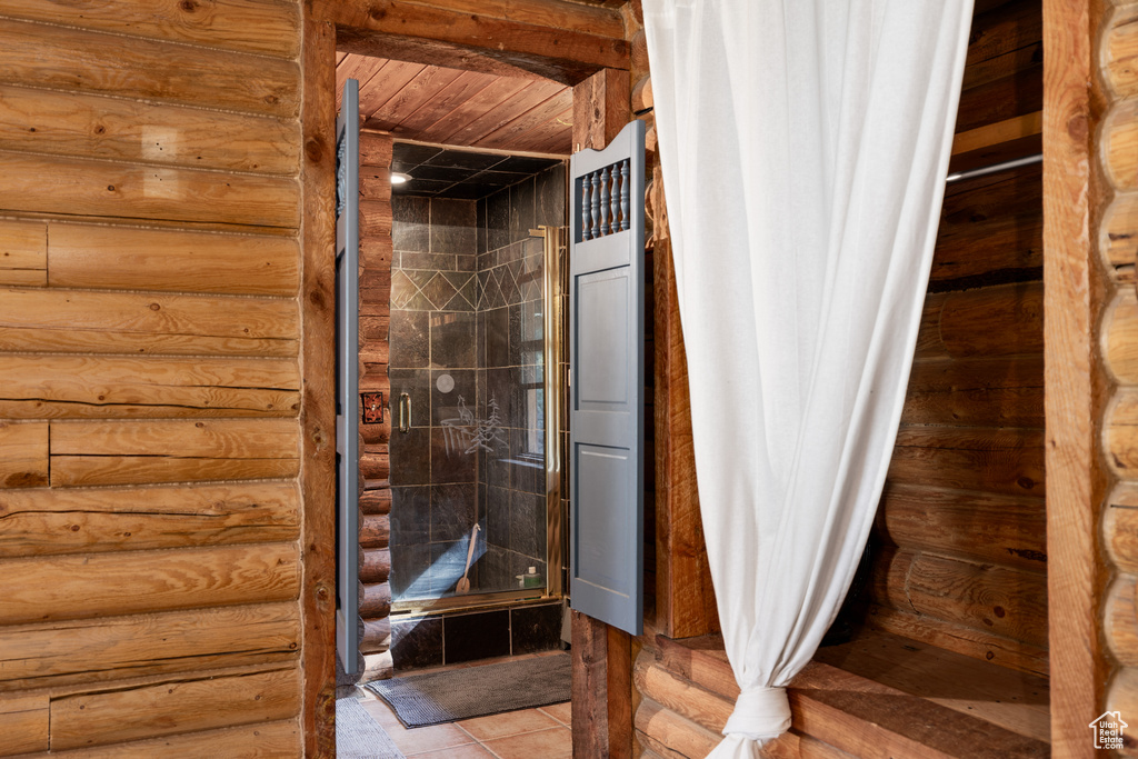 Bathroom featuring tile patterned floors and wooden ceiling