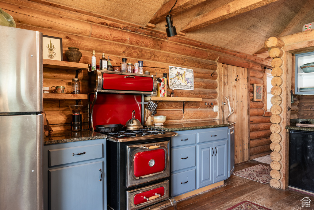 Kitchen featuring wood ceiling, dark wood-type flooring, stainless steel refrigerator, and rustic walls