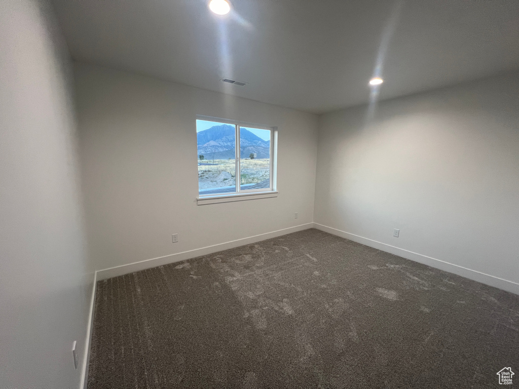 Unfurnished room featuring carpet floors and a mountain view