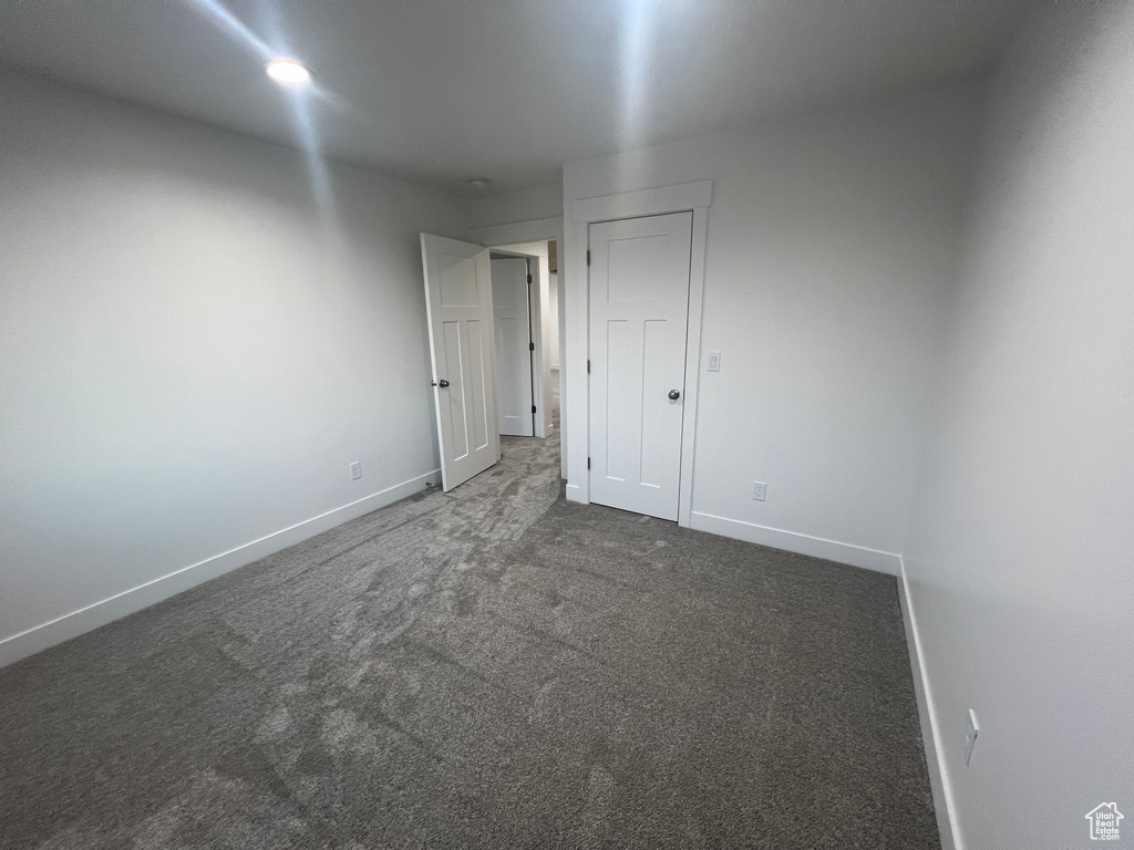 Unfurnished bedroom with carpet