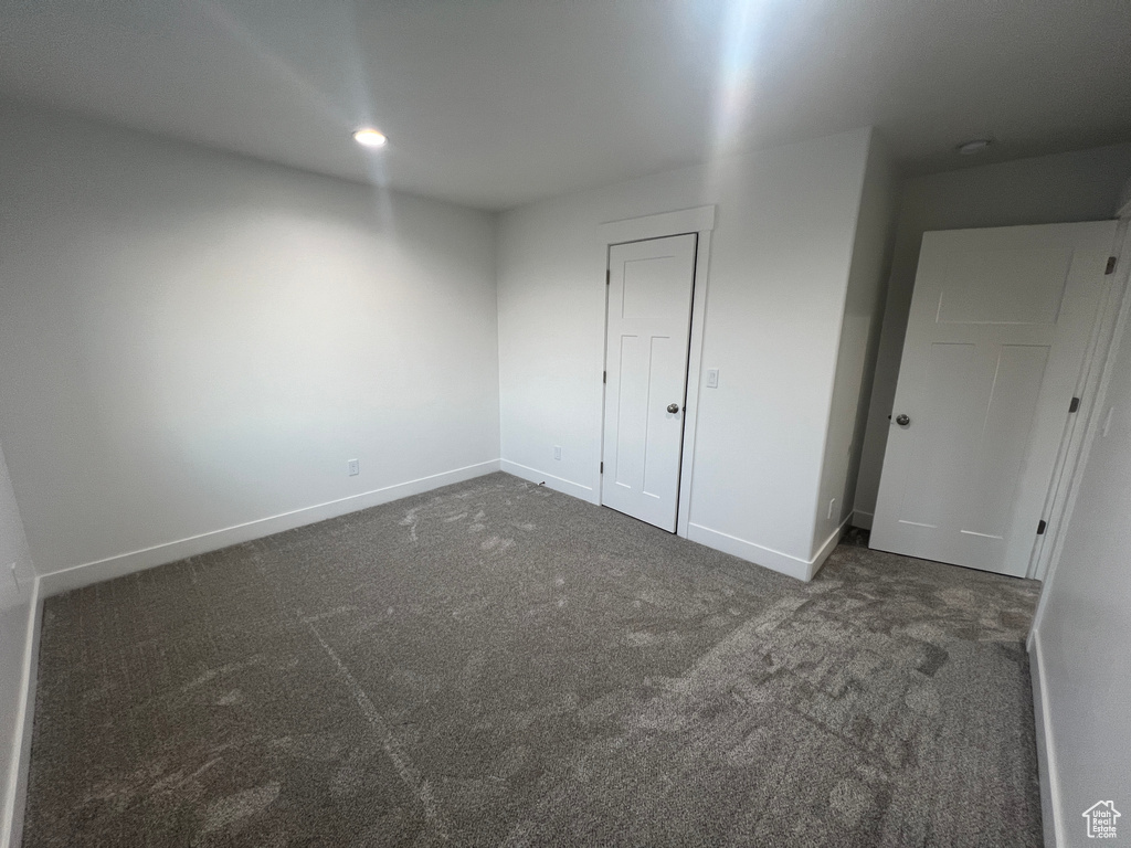 Unfurnished bedroom with carpet flooring